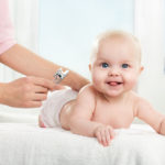 Pediatric doctor exams little baby girl with stethoscope