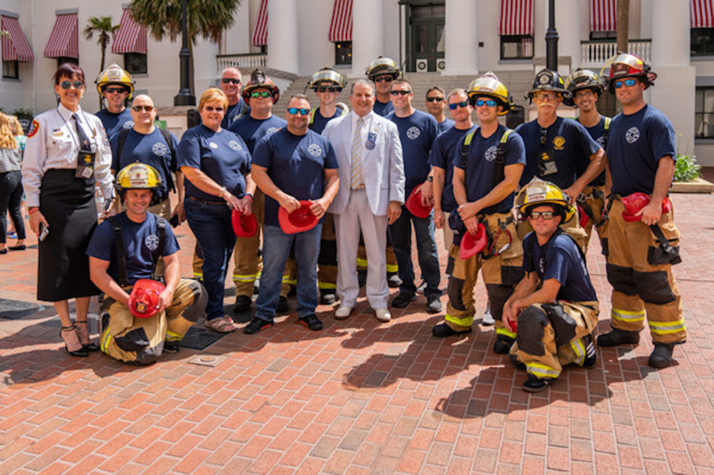 CFO and State Fire Marshal Jimmy Patronis poses with firefighters from across Florida in front of Florida's historic old capitol building.