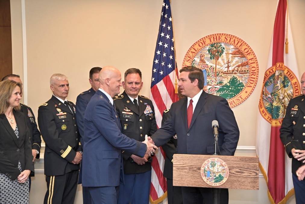 Major General James O. Eifert shakes hands with Governor Ron DeSantis.