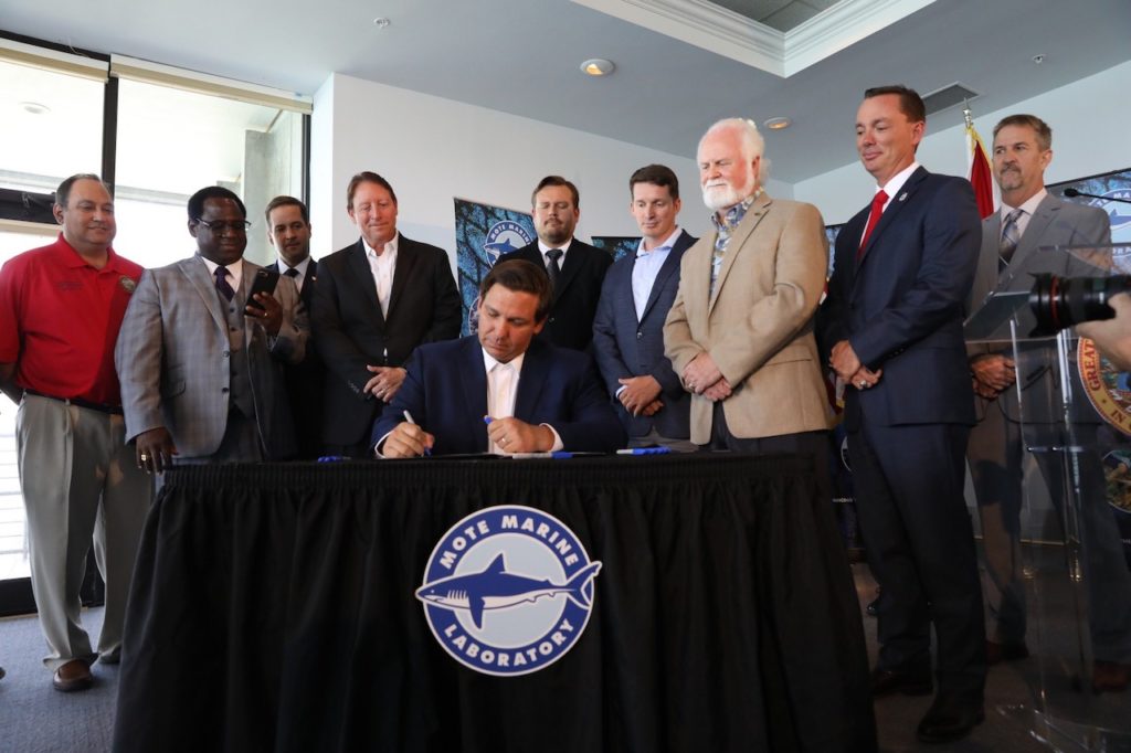 Photo of Governor Ron DeSantis signing the Florida Red Tide Mitigation and Technology Development Initiative.