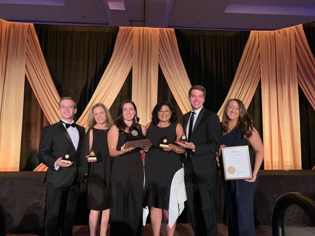 The Sachs Media Group team poses with their awards.