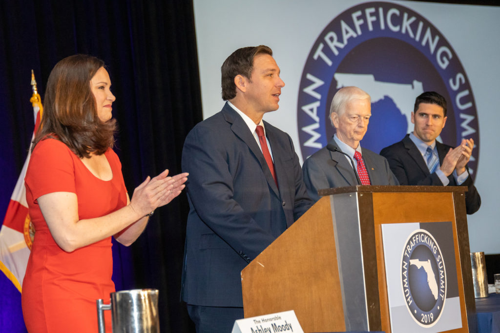 Photograph of Governor Ron DeSantis standing at podium speaking at the 2019 Human Trafficking Summit.