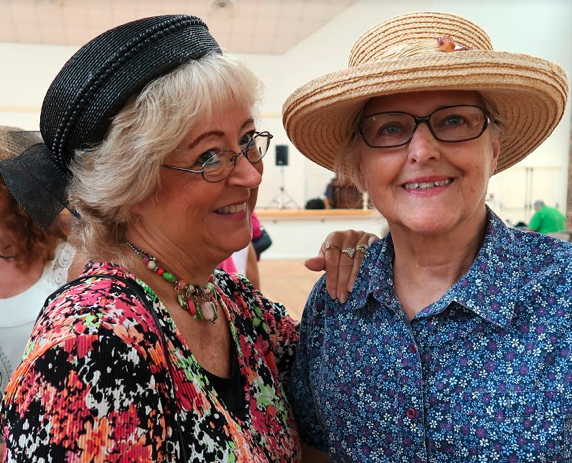 Two Tallahassee senior citizen women pose for a photograph at the inaugural Hats & Flats Dance in Tallahassee.