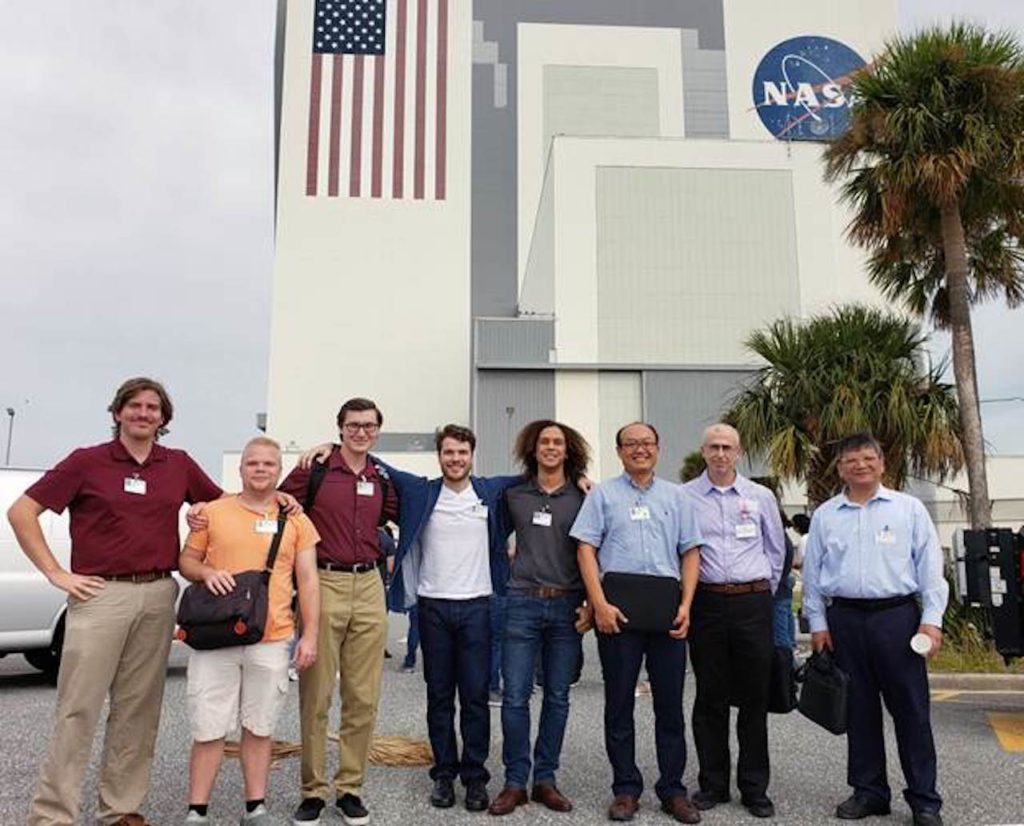 Florida Polytechnic University students Edward Davis, left, Brandyn Langston, Skyler Batteiger, Gabe Gamet, and Purcell Anderson, and faculty members Dr. Younggil Park, Dr. Onur Toker, and Dr. Feng-Jen Yang visit Kennedy Space Center as part of a team collaborating on a capstone project designing a planetary rover for the Florida Space Institute.