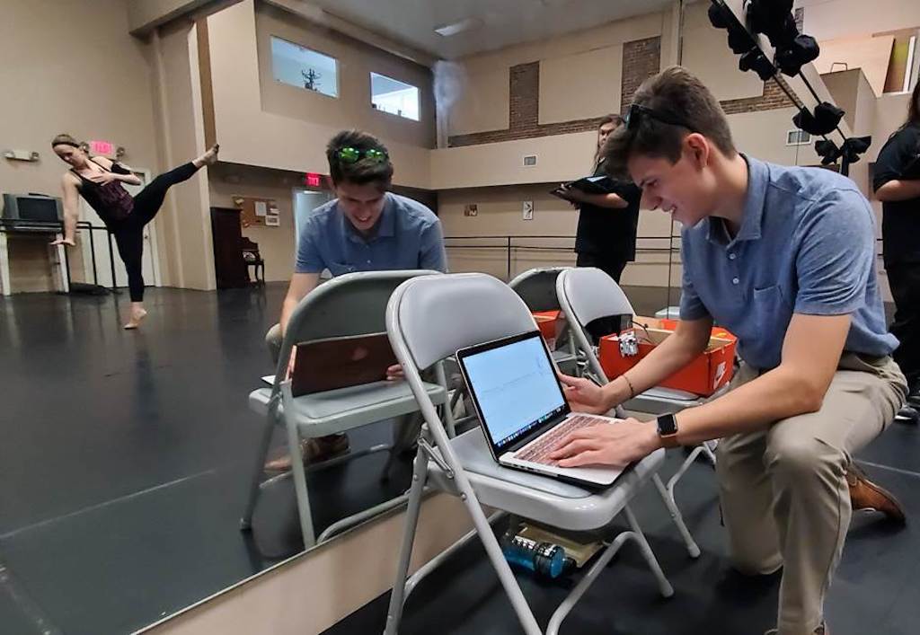 Jaimie Davis, an electrical engineering student at Florida Polytechnic University, monitors biosensor data generated by the movements of Florida Dance Theatre dancer Katrina Ogden in early March.