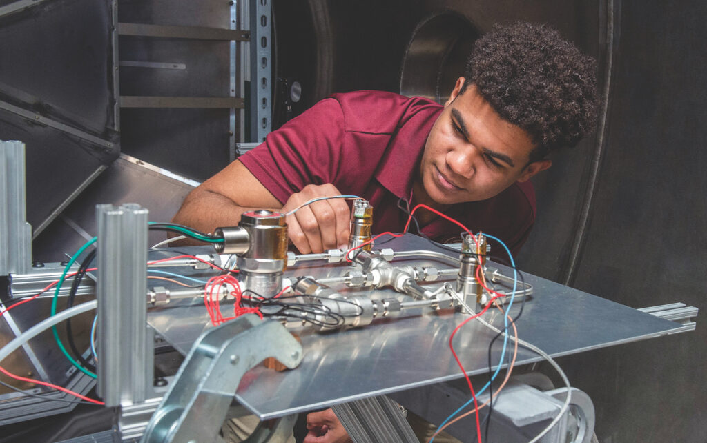 Senior mechanical engineering student Zachary Barnes works on his senior design project, Psyche Xenon Controller, testing at NASA/Marshall Space Flight Center in Huntsville, AL.