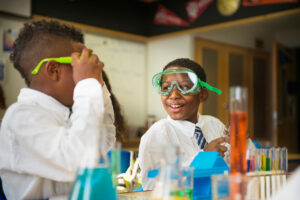 Children wearing goggles in science class