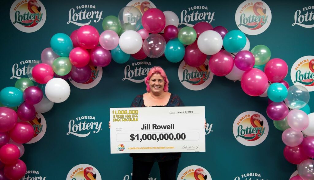 Jill Rowell poses with oversized check after claiming a $1 million prize from the $1,000,000 A YEAR FOR LIFE SPECTACULAR Scratch-Off game at Florida Lottery Headquarters in Tallahassee.  